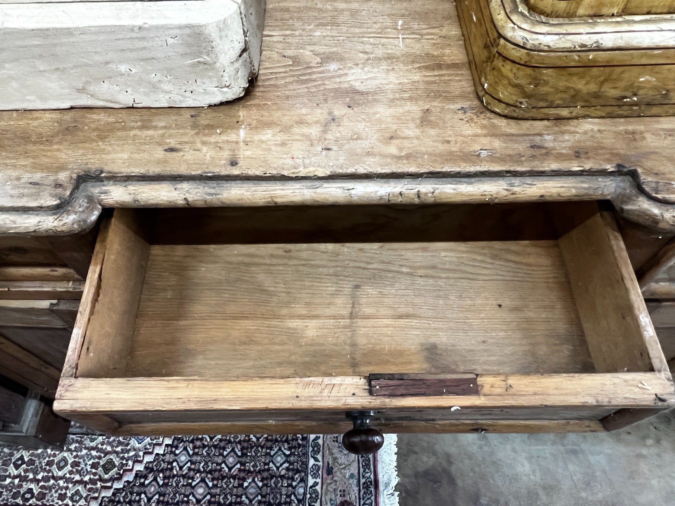 A Victorian pine inverse breakfront kneehole desk, width 119cm depth 49cm height 77cm